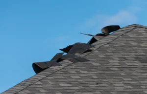 Curled shingles on a black asphalt roof